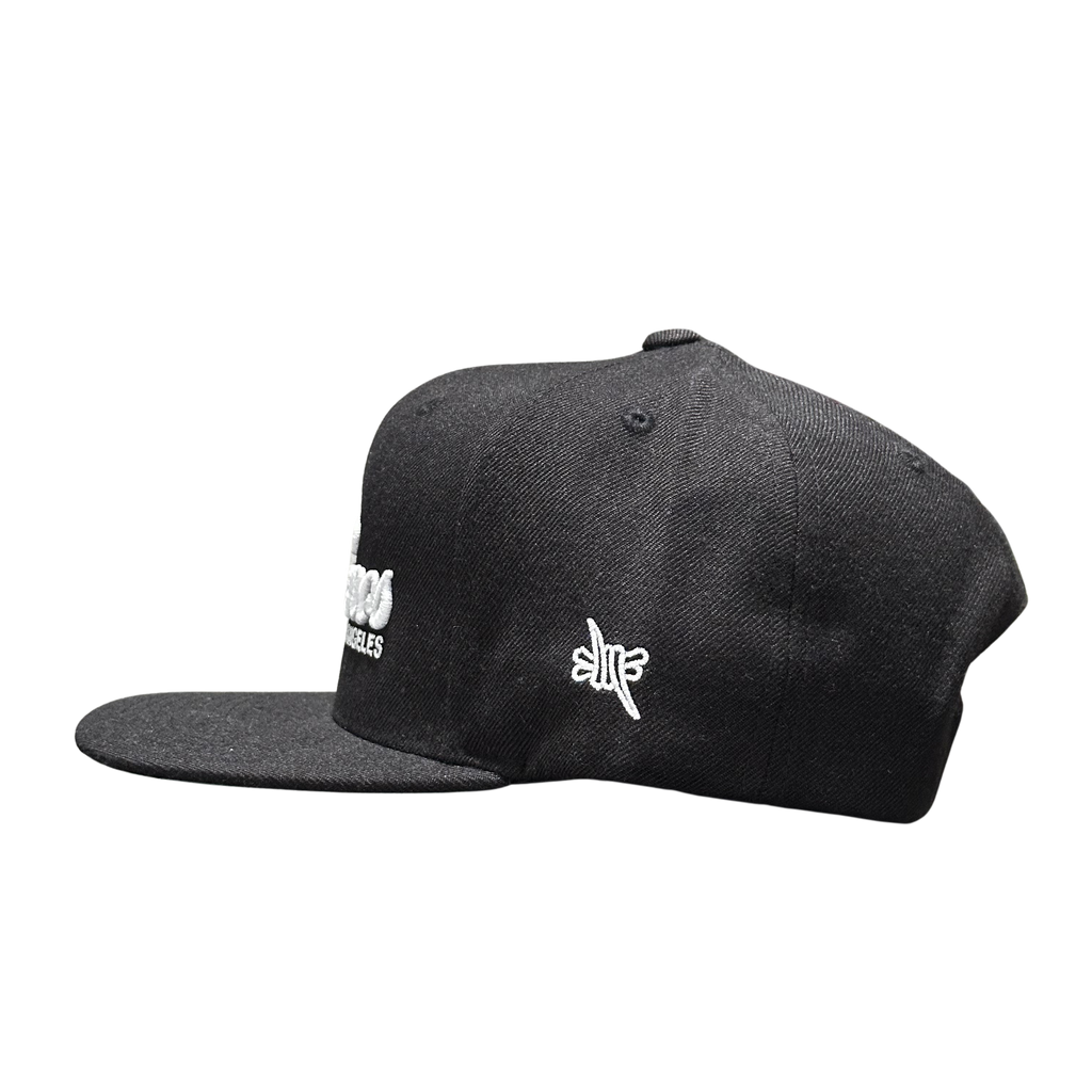 Sin Frenos Script Snapback cap in black.